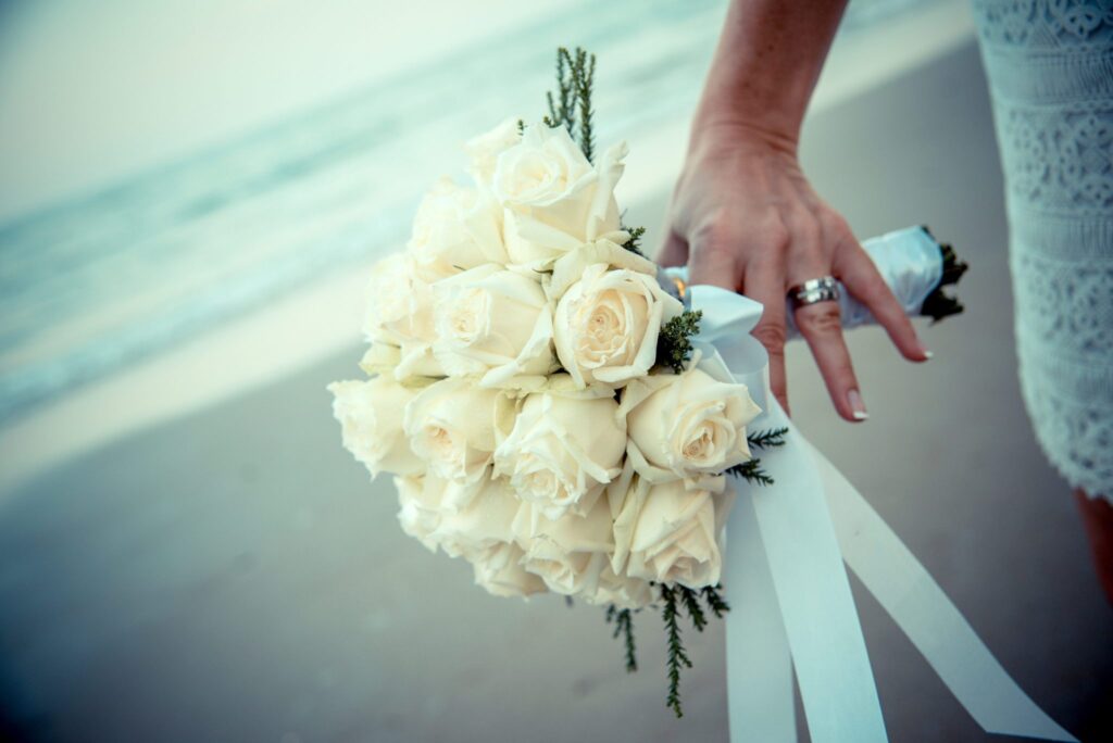 Bride hands on white flowers
