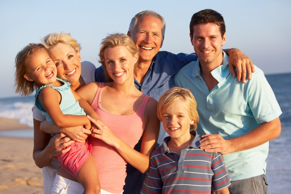 Family posing on the beach.