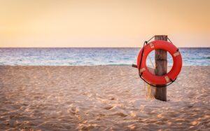 Life preserver ring on beach.