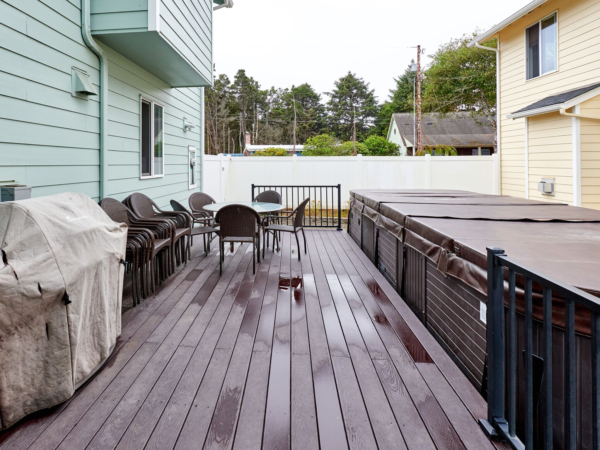 Vacation home patio deck with furniture and grill.