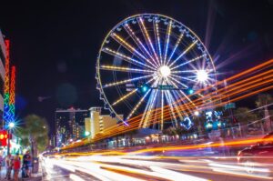 Timelapse photo of street and ferris wheel.