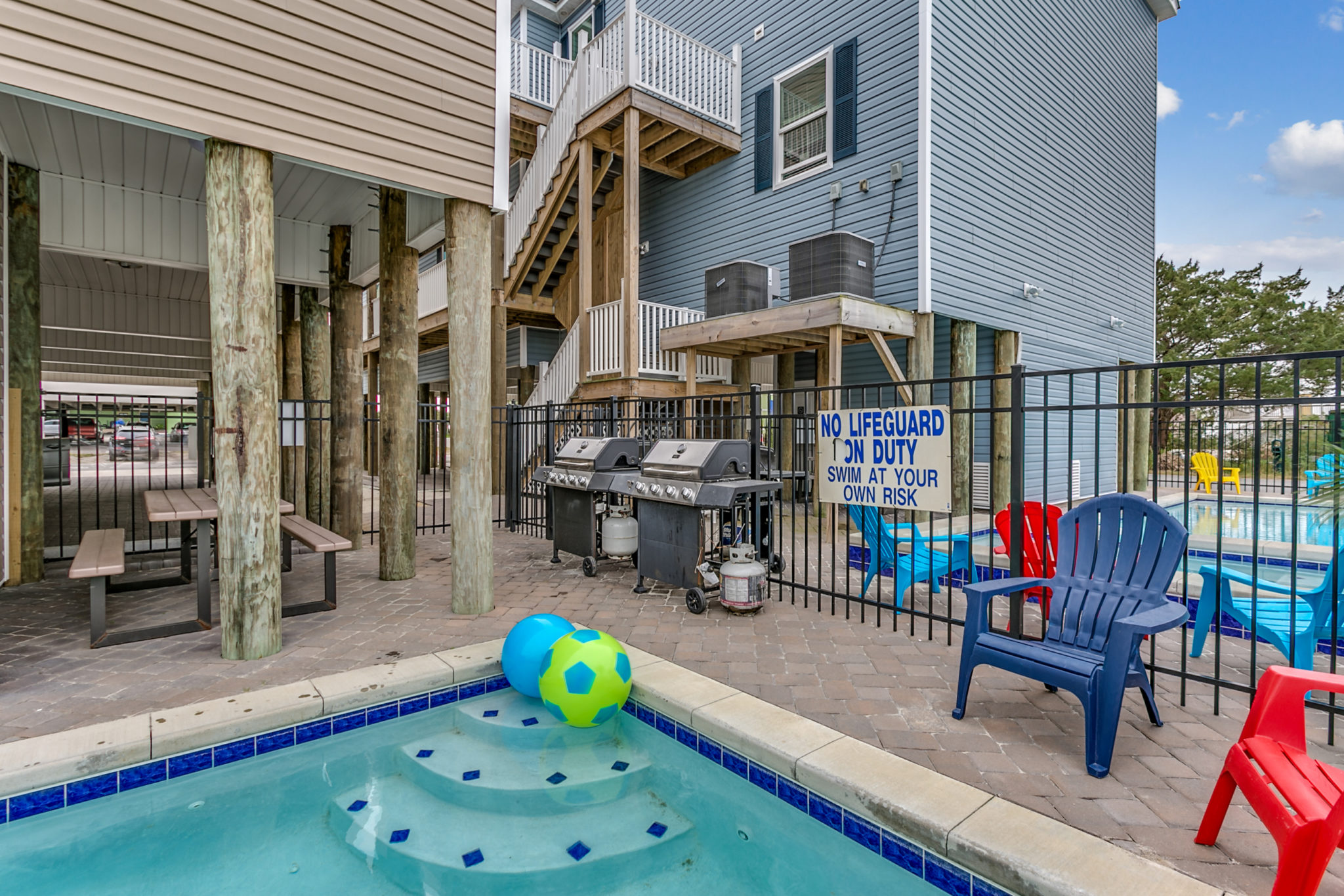 2201 Spring Street outdoor pool, patio, picnic table, gas grills, Adirondack chairs.