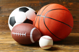 Soccer ball, basketball, football and baseball.