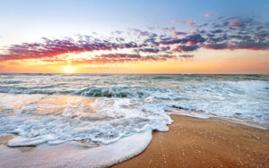 Beach at sunrise with tide.