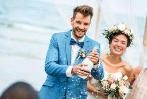 Bride and groom with champagne bottle