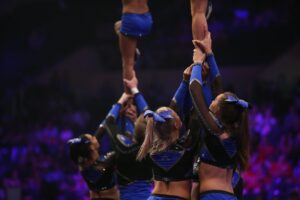 Cheerleaders forming a pyramid.
