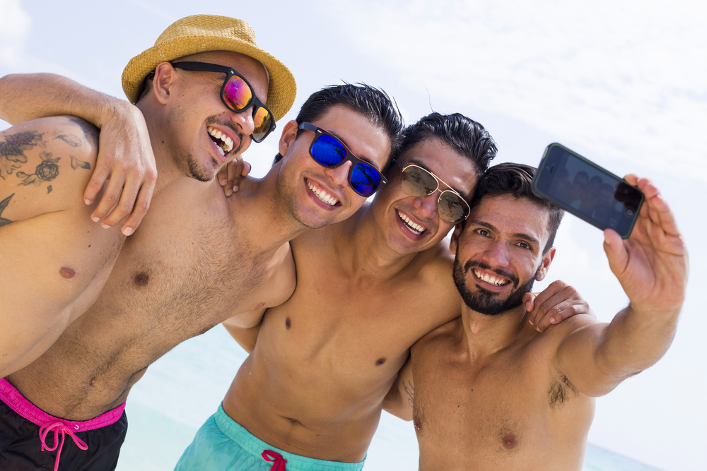 Four men taking a selfie.