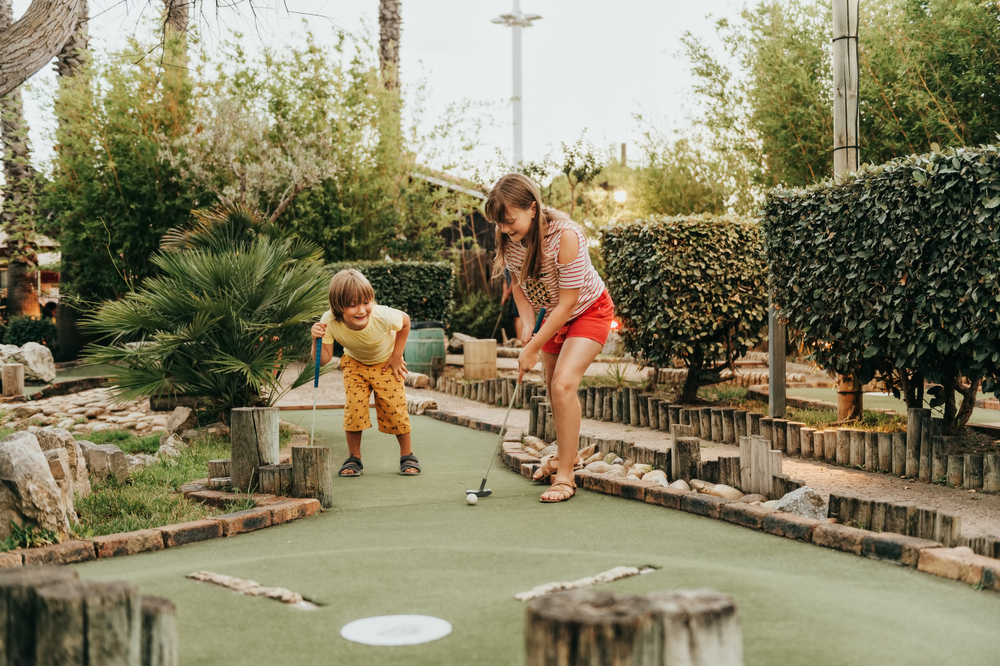 Photo of kids playing mini golf.