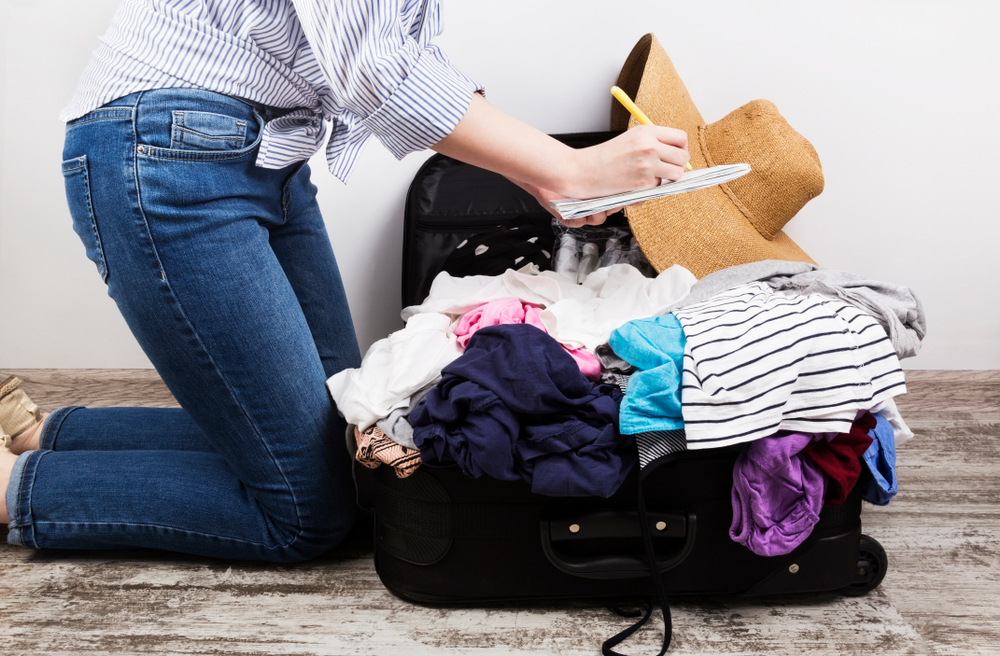 Photo of a Woman Making a Myrtle Beach Vacation Packing List.