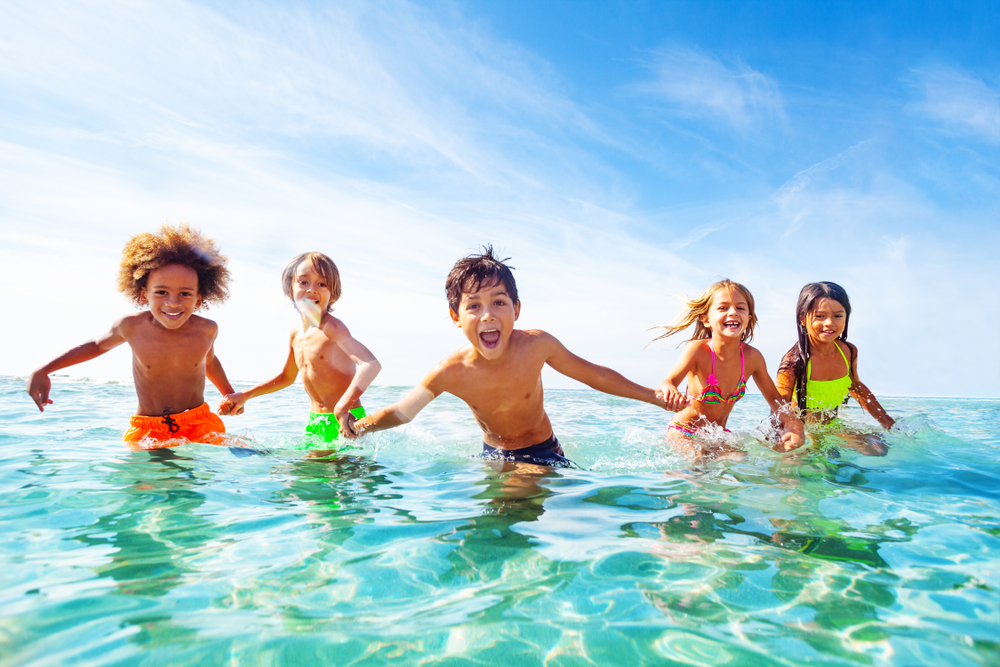 Kids play in the ocean water in kid-friendly Myrtle Beach.