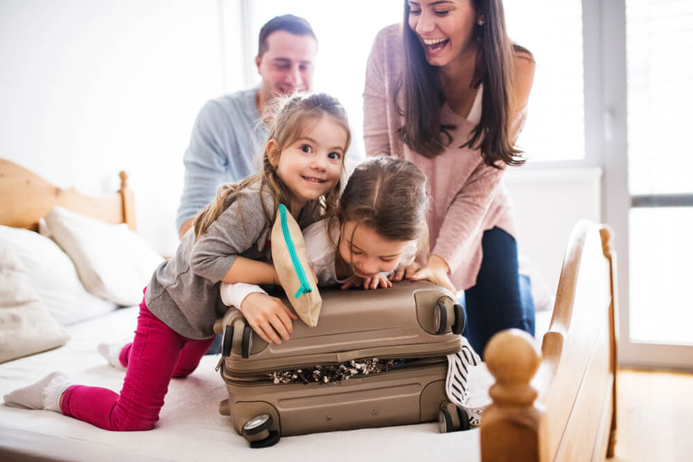 A family of four can be seen happily packing for their Myrtle Beach spring break.